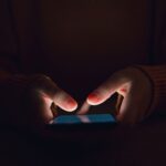Woman using smartphone in the dark
