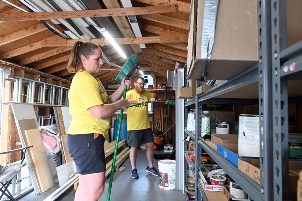 Monica Beistline of Bechtelsville and Pastor Scott Campbell of the Birdsboro Church of the Nazarene assemble brooms in the supply shed at St. Mark's Lutheran Church in Birdsboro during Mission Trip Birdsboro on Thursday, July 16, 2026. (BILL UHRICH/READING EAGLE)