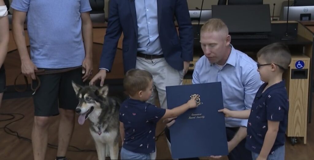 A husky is honored for saving a boy from a wild bear running across the driveway of a Connecticut home.